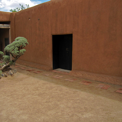 Black Door In Adobe Wall Made Famous By Georgia Okeeffe
