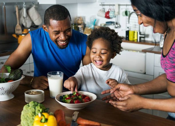Black family eating healthy food together Black family eating healthy food together asian family eating together stock pictures, royalty-free photos & images