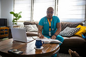 istock Black Female Nurse Studying Between Shifts 1301454918