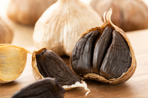 Black garlic, garlic fermented healthy food Black garlic, garlic fermented healthy food fermented garlic stock pictures, royalty-free photos & images