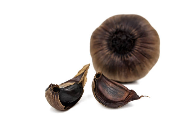 black garlic on white stock photo