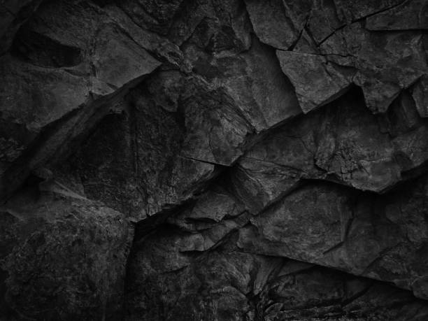 Black grunge texture. Dark gray stone background. Black rock texture. Fragment of a mountain close-up. Abstract geometric gray black white pattern background. Black stone backdrop. basalt stock pictures, royalty-free photos & images