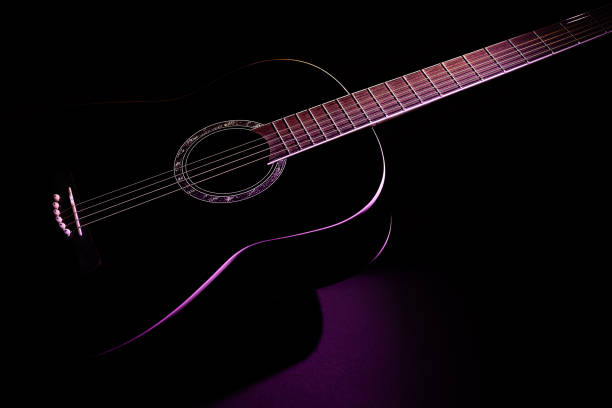 black guitar isometric view close-up. guitar music low-key concept black guitar isometric view close-up. guitar music low-key concept chiaroscuro stock pictures, royalty-free photos & images