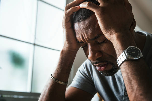 Black guy stressing and headache stock photo