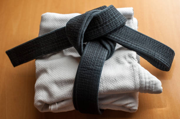 Black judo, aikido, or karate belt, tied in a knot Black judo, aikido, or karate belt, tied in a knot bushido lifestyle stock pictures, royalty-free photos & images