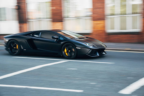 Black Lamborghini sports car in motion stock photo