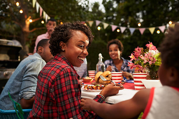 Black mother and son at family 4th July barbecue, Black mother and son at family 4th July barbecue, close up asian family eating together stock pictures, royalty-free photos & images