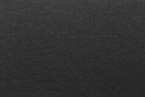 black paper sheet texture cardboard background. stock photo