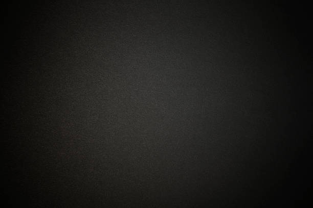 black paper texture background with spotlight - siyah renk stok fotoğraflar ve resimler