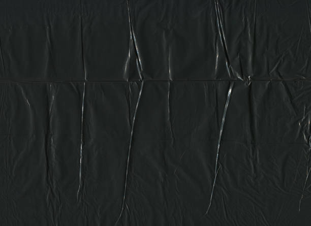 black plastic bag pattern texture background front view closeup of wrinkled dark black plastic bag pattern texture background plastic stock pictures, royalty-free photos & images