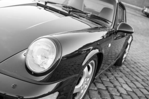 Black Porsche 911 - black and white image- during the event with Magnus Walker on the Fish Market Hamburg Hamburg, Germany - August 8. 2017: Magnus Walker - Car collector / builder of classic Porsches was in Hamburg: Drivers with their cars were invited to come to the fish market and have a good time. porsche 911 stock pictures, royalty-free photos & images