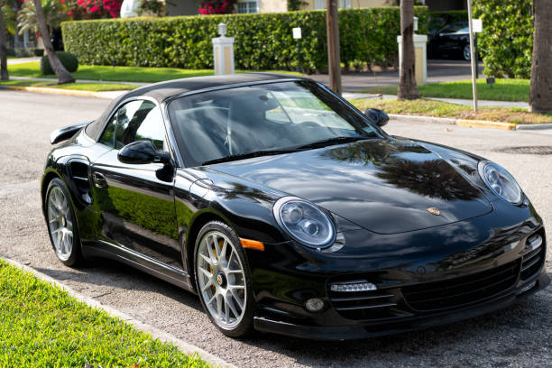 black Porsche 911 cabriolet. right corner view. Palm Beach, Florida USA - March 21, 2021: black Porsche 911 cabriolet luxury car parked in palm beach, united states of america. right corner view. Porsche is luxury car brand porsche 911 stock pictures, royalty-free photos & images