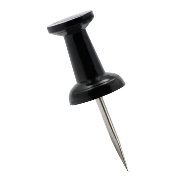 Black pushpin thumbtack drawing pin, isolated push fastening, position indicating concept, large detailed macro closeup stock photo