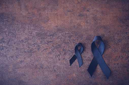 black ribbons on dark toning background for Skin cancer awareness, Melanoma Awareness,Narcolepsy Awareness and Mourning