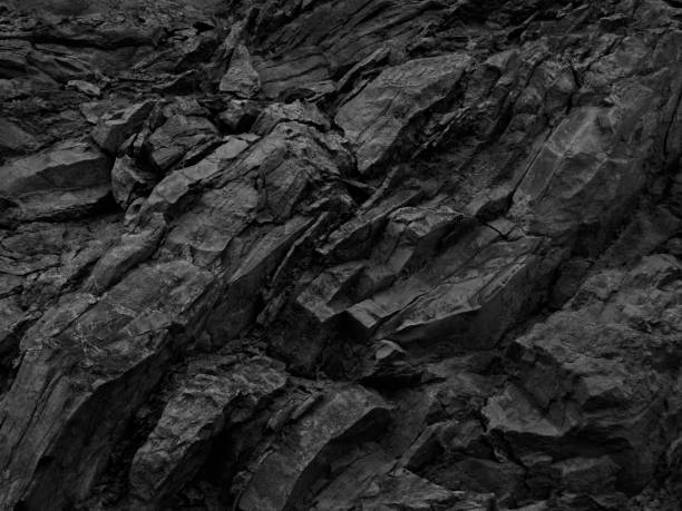 Black rock background. Dark gray stone texture. Black grunge background. Mountain close-up. Distressed backdrop. Black rock grunge texture background for your design. Distressed background. basalt stock pictures, royalty-free photos & images