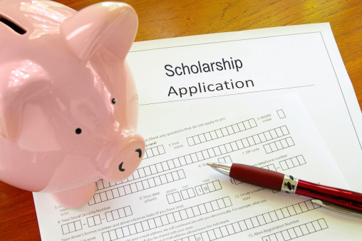 Picture of a scholarship application form and a piggy bank