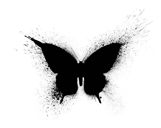 Black silhouette of a butterfly with paint splashes and blots, isolated on a white background. stock photo