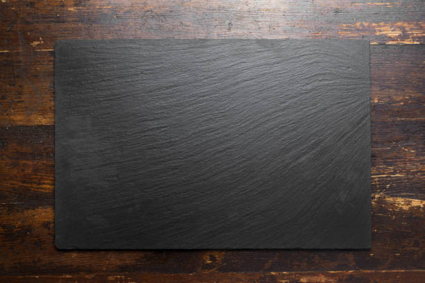 black slate board on wooden background. stock photo