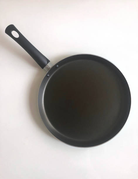 Black teflon pancake pan isolated on white background stock photo