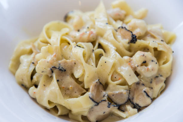 Black truffle pasta with shrimps stock photo