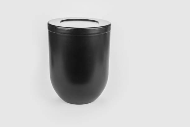 Black urn of human ashes for funeral on a white Black urn of human ashes for funeral on a white funerary urn stock pictures, royalty-free photos & images
