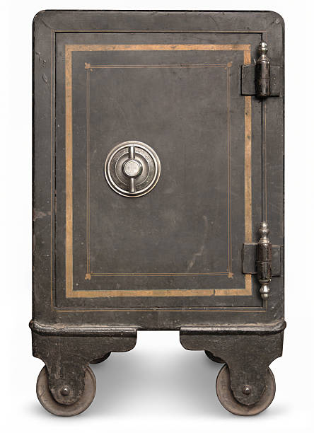 Black vintage safe on wheels with golden frame Antique iron safe isolated on white background with clipping path safes and vaults stock pictures, royalty-free photos & images