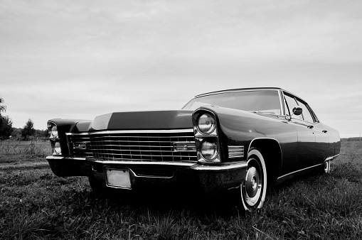 Black & White photo of an old 1967 car parked in a field
