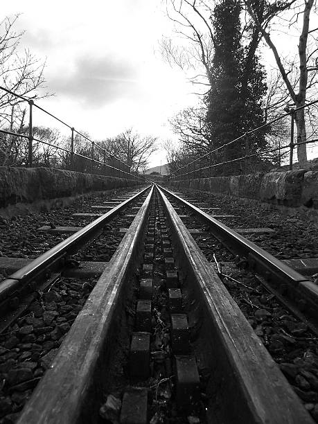 Black & White Track A picture of the Snowdon Mountain Railway track over a brick bridge, the track has teeth for extra grip to clime the steep gradients. normalisaverage stock pictures, royalty-free photos & images