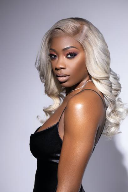 Black woman with Blonde Wig black girl with platinum blonde wig getting her make up done wig stock pictures, royalty-free photos & images