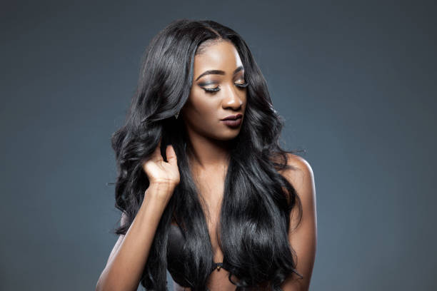 Black woman with long luxurious shiny hair Black beautiful woman with long luxurious shiny hair black hair stock pictures, royalty-free photos & images