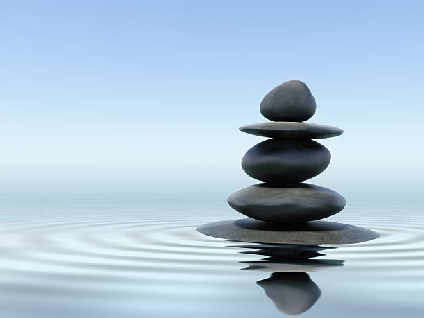 Black zen stones in shallow water Zen stones in water with reflection zen stock pictures, royalty-free photos & images
