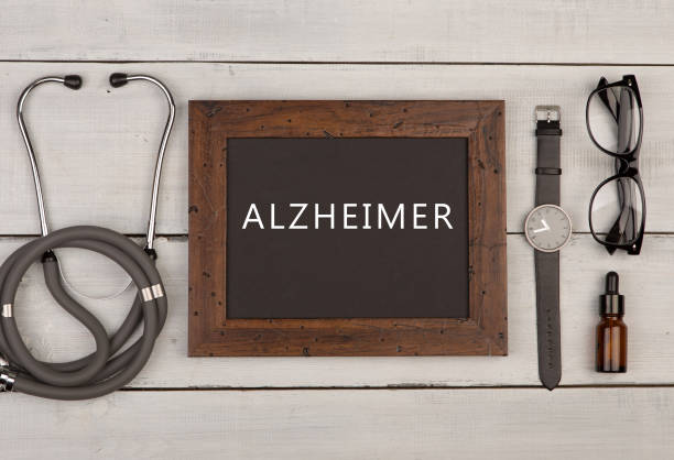 blackboard with text "Alzheimer", eyeglasses, watch and stethoscope stock photo