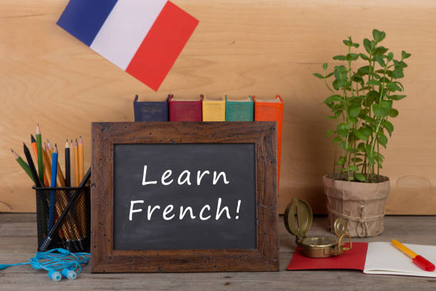 blackboard with text "Learn French!", flag of the France stock photo