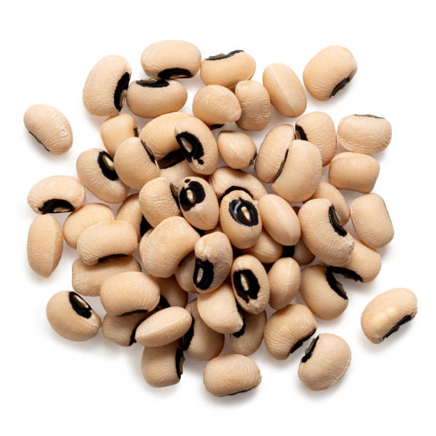 Black-eyed beans Pile of uncooked black-eyed beans isolated on white. Top view. black eye stock pictures, royalty-free photos & images