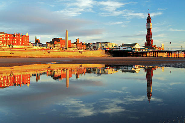 Blackpool North Pier Reflection A beach golden hour calm evening reflection of the world famous Blackpool Tower and North Pier on the Lancashire Riviera blackpool tower stock pictures, royalty-free photos & images