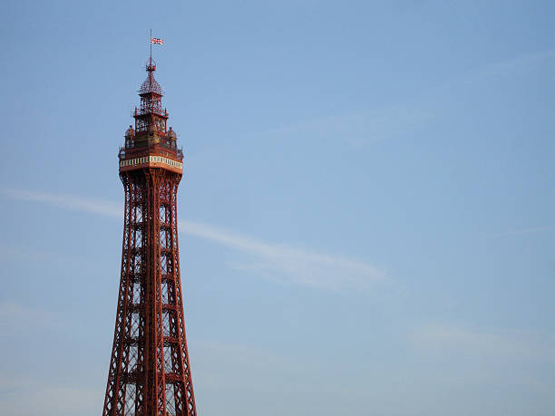 Blackpool Tower against blue sky Iconic Blackpool Tower against summer blue sky with few wispy clouds blackpool tower stock pictures, royalty-free photos & images