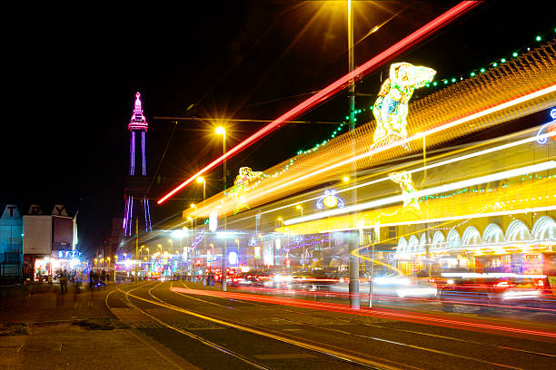 Blackpool Tower and The Golden Mile Illuminations at night The Famous Blackpool Tower and lights along the stretch of promenade known as the Golden Mile in Blackpool, Lancashire at night, photographed on a long exposure with light streaks during the yearly 'illuminations' spectacle. blackpool tower stock pictures, royalty-free photos & images