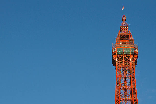 Blackpool Tower Close-Up and Blue Sky Closeup of the top of the Victorian Blackpool Tower in Blackpool, Lancashire.  Photograpghed on a sunny day with a deep blue sky blackpool tower stock pictures, royalty-free photos & images