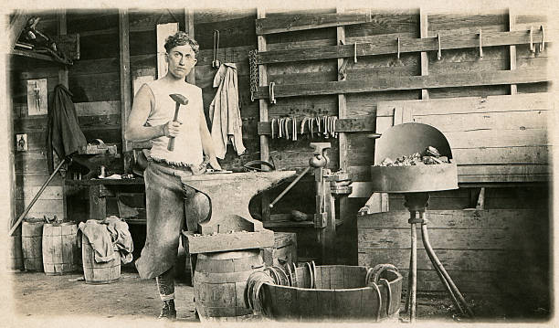 Blacksmith A 1914 photograph of a young blacksmith working in his shop - Fort Riley, Kansas, 12th Calvary. NOTE TO INSPECTOR: photo passed down in our family. blacksmith stock pictures, royalty-free photos & images