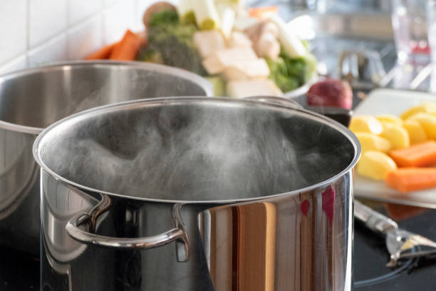 Blanching vegetables in big cooking pot preparation Blanching vegetables in big cooking pot preparation cooking pan stock pictures, royalty-free photos & images
