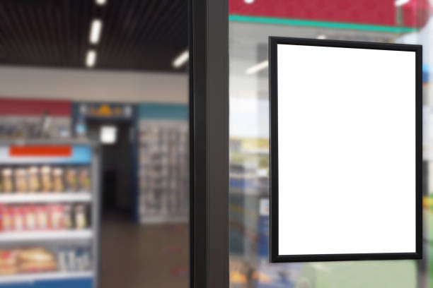 blank advertising billboard placard (clipping path) in the market window with blurred merket background - display ad imagens e fotografias de stock