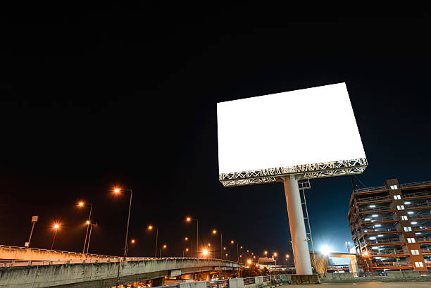 Blank billboard at night for advertisement. stock photo