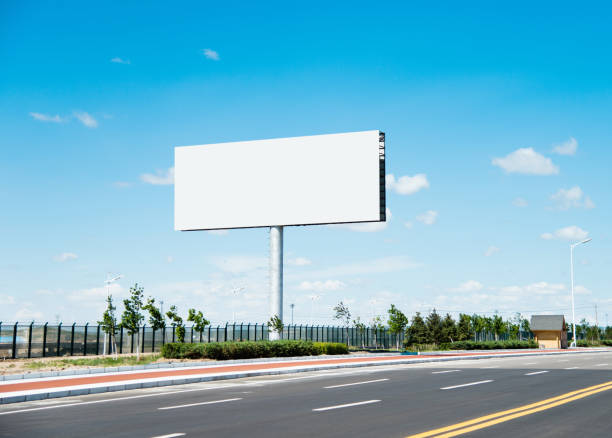 Blank billboard on the side of the road Blank billboard on the side of the road billboard posting stock pictures, royalty-free photos & images