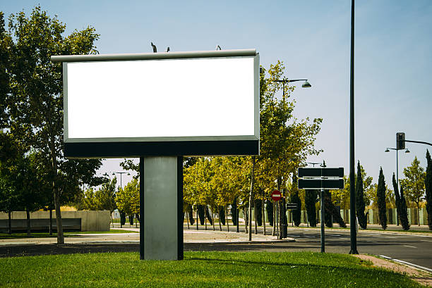 Blank billboard A blank billboard at a green area in a city. billboard posting stock pictures, royalty-free photos & images