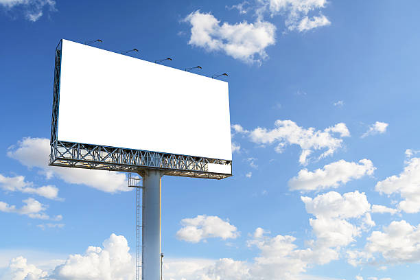 Blank billboard with blue sky and clouds for advertisement. stock photo