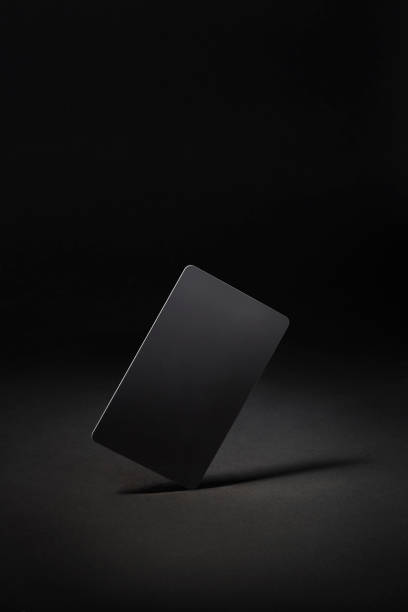 Blank black gift card isolated on black background stock photo