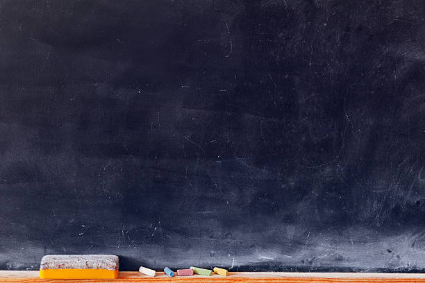 Blank blackboard with colored chalks Blank blackboard with colored chalks and eraser. Horizontal composition. chalk art equipment stock pictures, royalty-free photos & images