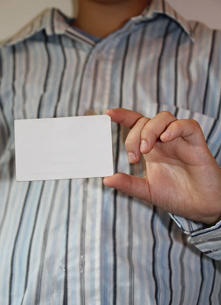 Blank business card in a businessman's hand stock photo