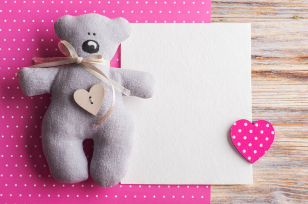 Blank card on pink background with teddy bear Blank card on pink polka dot background with teddy bear and heart. Baby shower party invitation or valentine day it's a girl stock pictures, royalty-free photos & images