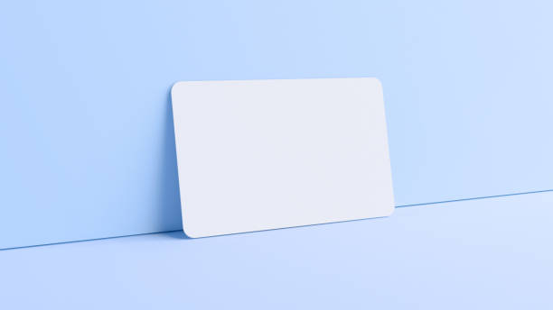 Blank credit card mockup resting on a wall in realistic 3D rendering. Rounded corners business card mock up for design template stock photo